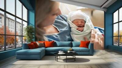 Mother with her newborn baby at the hospital a day after a natural birth labor Wall mural