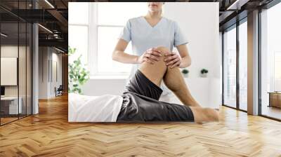 Patient at the physiotherapy doing physical exercises with his therapist Wall mural