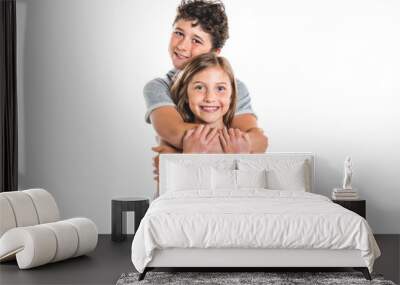 Portrait of cute girl and boy on studio white background Wall mural