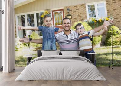 Portrait of happy family in front  house Wall mural