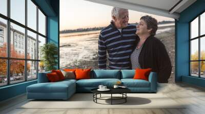 Portrait of loving senior couple at the beach Wall mural