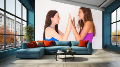 portrait of two 14 years old best friends girls close to a wall with color shirt Wall mural