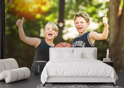 portrait of two boys kids playing with a basketball in park Wall mural