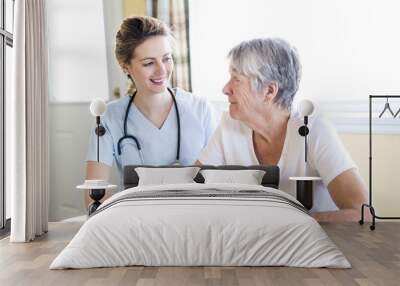 Senior woman with her caregiver at home Wall mural