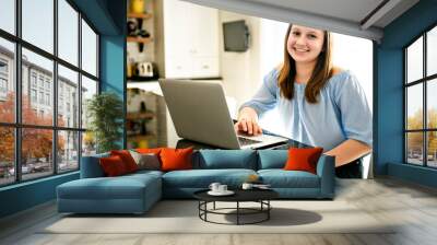 teenager girl using laptop studying in kitchen Wall mural