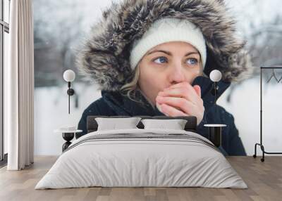 The girl with cold hand in winter season Wall mural