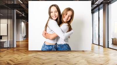 Two Young pre teen best friend girl on studio white Wall mural