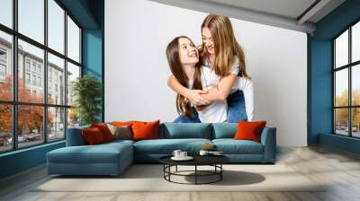 Two Young pre teen best friend girl on studio white Wall mural