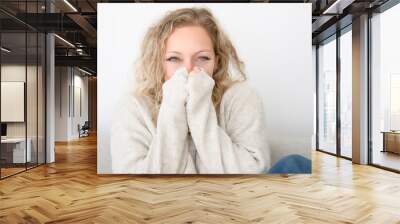 woman freezing sitting on sofa having symptoms coughing at home, flu concept Wall mural