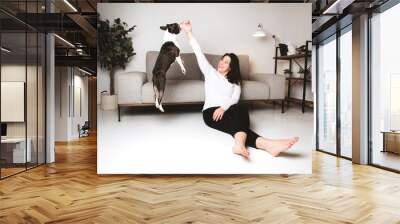 Woman with is Boston Terrier on the living room Wall mural