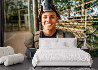 Young teen boy play baseball on a playground wearing catcher clothes Wall mural