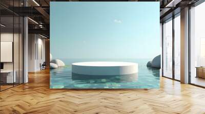 Serene natural podium display on clear water with smooth, large grey rocks surrounding it; the pedestal is made of polished white stone, reflecting the blue sky above; some green aquatic plants are vi Wall mural