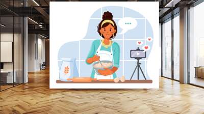 A young woman records a cooking video blog in the kitchen. Cooking video broadcast, channel or blog with an online cooking course. A female chef cooks healthy food at home. Vector illustration Wall mural