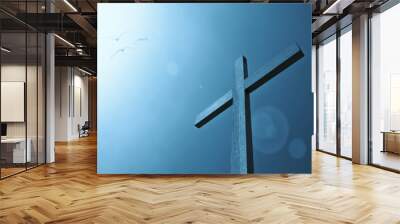 Cross with bird and sunlight blue sky Wall mural