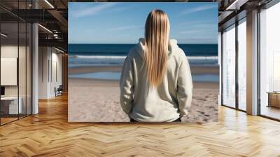 Back of hip blond tan woman wearing white thick oversized hoodie on the beach vertical view (14) Wall mural