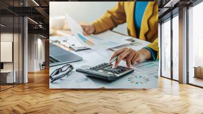 .Business woman working in finance and accounting Analyze financial budget in the office Wall mural