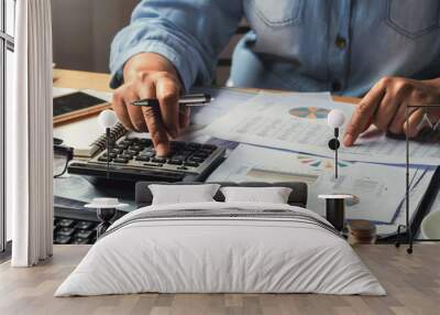 accounting concept. businesswoman working using calculator with money stack in office Wall mural