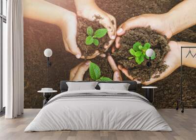 Growing concept eco Group hand  children planting together on soil background Wall mural