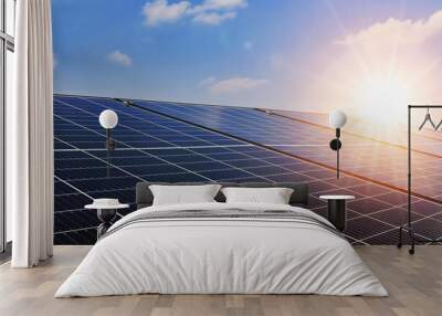 Solar panels with sunset and blue sky background. Clean power energy concept. Wall mural