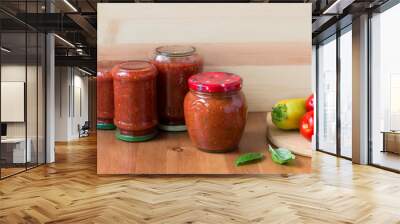 Homemade preserved tomato sauce with bell pepper, basil and oregano in a glass jar Wall mural