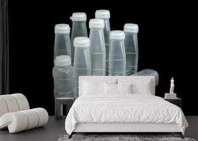 Plastic bottles and plastic caps of many sizes are placed together on a black background. Wall mural