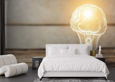 A light bulb shaped like a brain with a bright light shining from it, on a wooden table. Wall mural