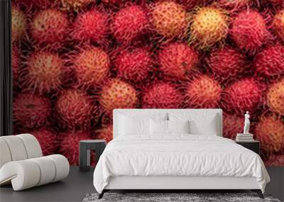 Rambutan fruit full frame. Graphic image made with pile of this exotic red fruit Wall mural