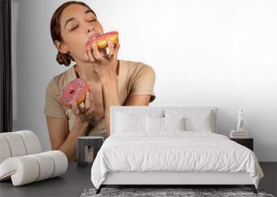 Woman eating a huge donut, Breaking diet with a mouth watering cake Wall mural