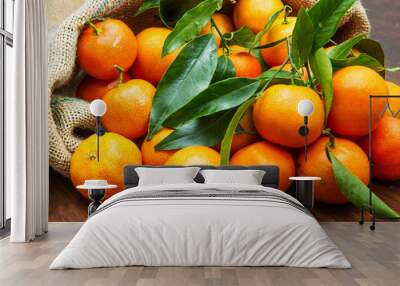 fresh mandarin oranges fruit with leaves on wooden table Wall mural