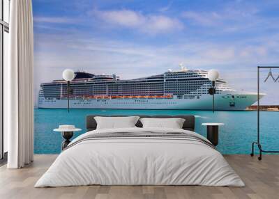 Luxury cruise ship sailing from port  Wall mural