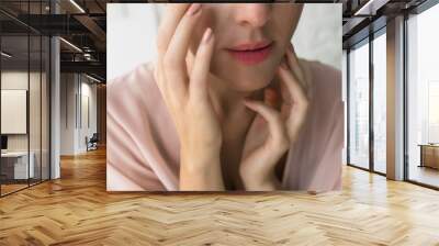 Woman Applying Creme Under Her Eye Wall mural