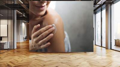 Woman Applying Moisturising Creme on Her Body Wall mural