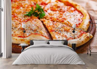 Italian Pizza Margherita with tomatoes and mozzarella cheese on wooden cutting board. Close up Wall mural