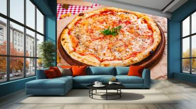 Italian Pizza Margherita with tomatoes and mozzarella cheese on wooden cutting board. Close up Wall mural