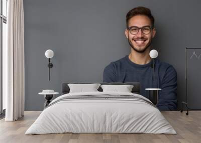 Portrait of young handsome smiling business guy wearing gray shirt and glasses, feeling confident with crossed arms, isolated on white background Wall mural