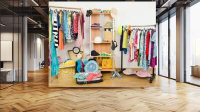 Wardrobe with summer clothes nicely arranged and a full luggage. Wall mural