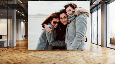 .Group of beautiful friends sharing laughs together on their trip to Porto in Portugal. Walking along the coast a windy afternoon. Lifestyle. Travel photography Wall mural