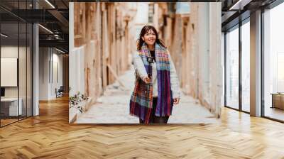 .Young female tourist touring Valletta, capital of Malta. Travelling with a compact camera to broadcast her trip on social networks. Lifestyle Wall mural