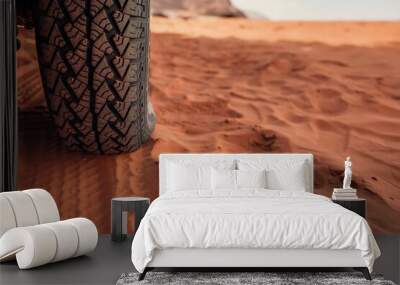 4wd vehicle tyre, dirty from dust - track print visible in red sand, closeup detail Wall mural