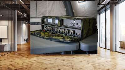 military grade ruggedized ethernet network switch on a desk in army tent, closeup detail Wall mural