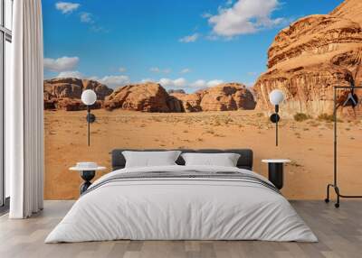 Rocky massifs on red sand desert, bright blue sky in background - typical scenery in Wadi Rum, Jordan Wall mural