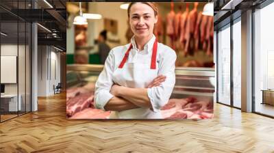 Young woman standing in front of shelves with raw meat. Female butcher working in modern meathsop. Generative AI Wall mural