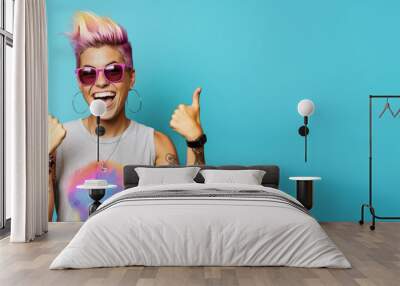 Young woman with colourful dyed hair, sunglasses, some tattoos, cheeky attitude, smiling and showing approving thumbs up. Wide banner copy space on side. Generative AI Wall mural