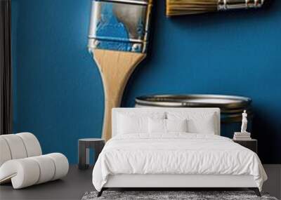 Blue paintbrush and cans on textured blue surface with brush strokes. Wall mural