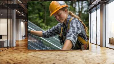 Female technician installing solar panel on house roof Wall mural