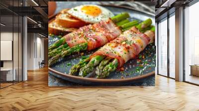 Plate with baked asparagus wrapped in Parma ham, an egg and toast next to it. Wall mural