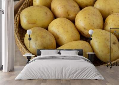 Raw potato in a wicker bowl Wall mural