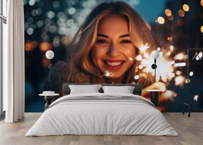 Young woman holding a sparkler in the Christmas season Wall mural