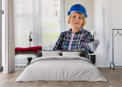 Woman Builder in the room making repairs. Wall mural