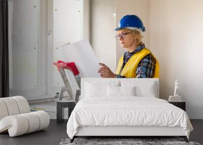 Woman Builder in the room of the house making repairs. Wall mural